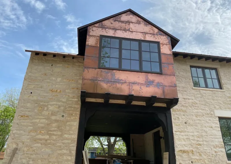 Copper metal panel facade on a stone building for Metal Roof Coating in Centerville